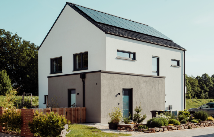Eco-friendly home with solar panels and a green roof.
